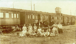 814023 Afbeelding van enkele gezinnen bij oude rijtuigen van de Staatsspoorwegen (S.S.), ingericht als noodwoningen ...